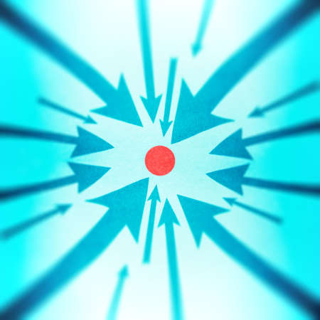 Blue arrows pointing to one red point.の写真素材