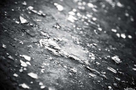 Broken glass on a ground closeup. Black and white concept.