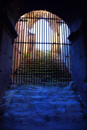 Closed wrought-iron gate in an underground. HDR image.の写真素材