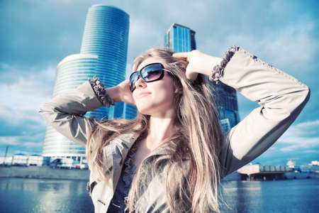 Young woman on modern city background. Wide angle view.の写真素材