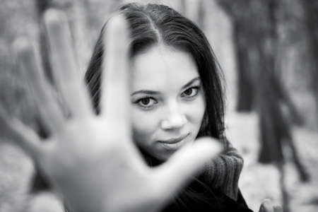 Woman stretching hand to the camera. Black and white concept.の写真素材