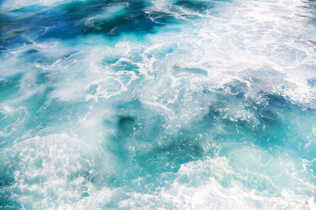 Foam on ocean water. Turquoise water color.