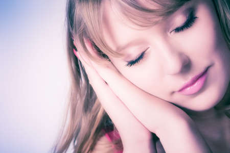 Sweet sleeping woman. Soft pink tint.の写真素材