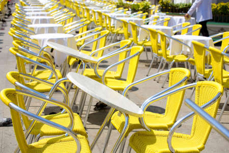 Restaurant tables outdoors. Lots of tables.の写真素材