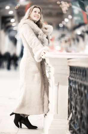 Young woman in winter clothing in trade center. Shallow dof.の写真素材