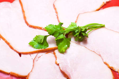 Tasty ham with green dill. Food closeup.