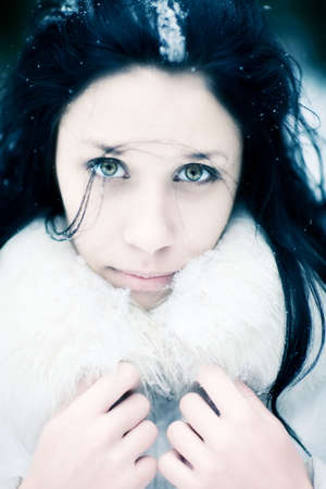 Young woman winter portrait. Blue and white tint.の写真素材