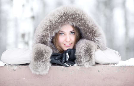 Young woman winter portrait. Soft white colors.の写真素材