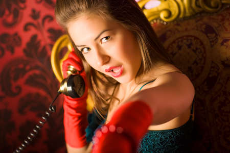Young woman talking on phone. Retro style.の写真素材