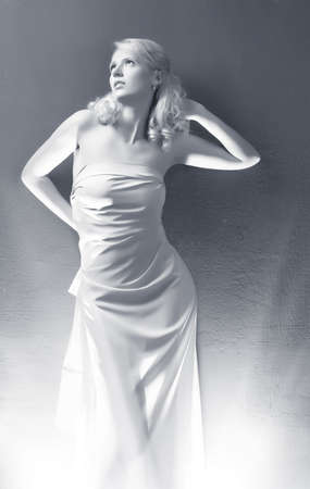 Young woman on wall background. Black and white.の写真素材