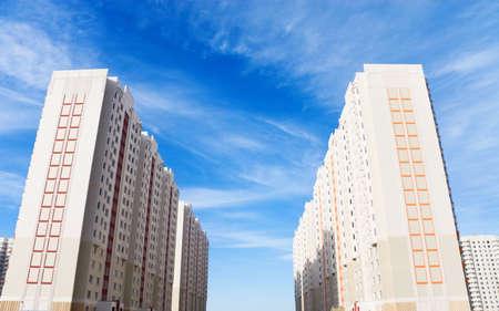 Two modern buildings on blue sky background. Perspective effect.