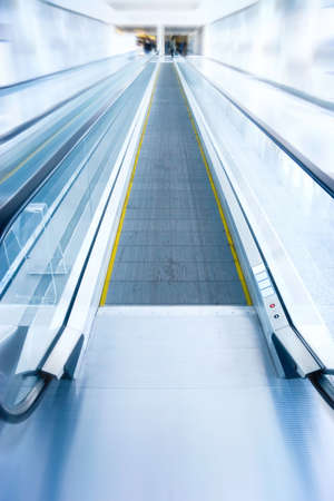 Moving staircase in modern business center. Zoom blur effect.の写真素材
