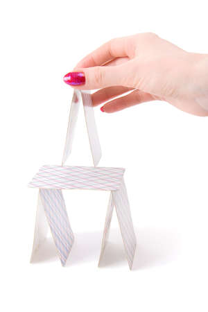 Woman hand building house from playing cards. Isolated on white.のeditorial素材