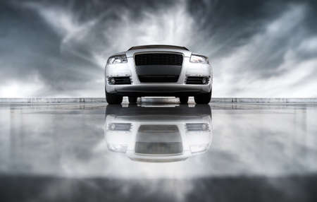 Modern car front view. On sky background and with reflection.の写真素材
