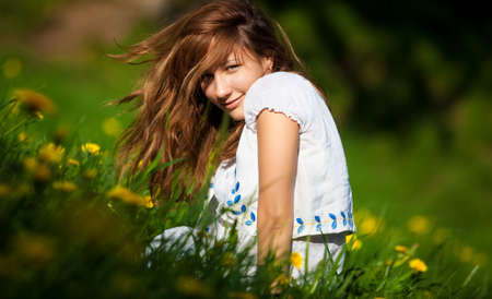 Young woman on a summer field. Shallow dof.の写真素材