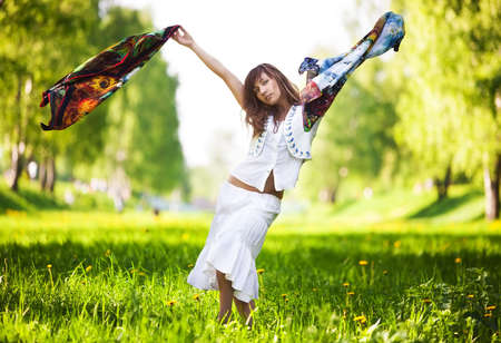 Young woman dancing in a park.の写真素材