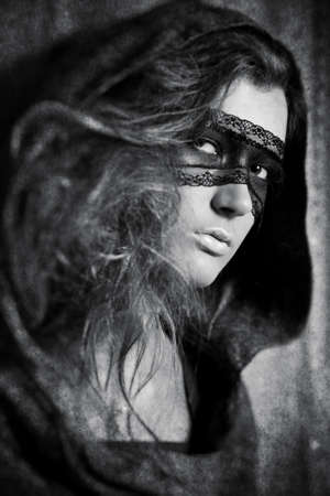 Young woman with mask. Black and white concept with aged effect.の写真素材