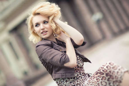 Pensive woman street portrait. Soft yellow tint.の写真素材