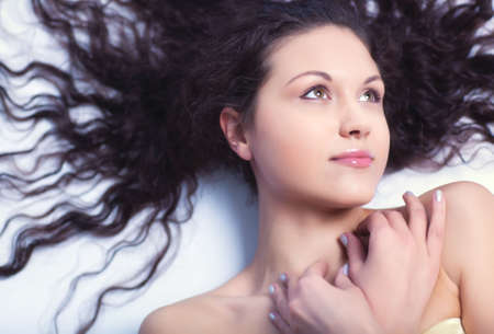 Young woman with long curly hair.