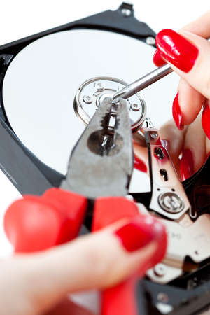 Woman repairing computer HDD. Isolated on white.の写真素材