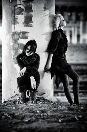 Two goth women at the column. Contrast black and white colors.の写真素材