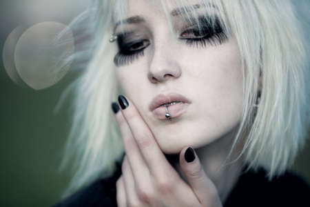 Goth woman with white hair outdoors portrait. Shallow dof effect.の写真素材