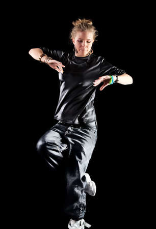 Young woman modern dance. Isolated on black.