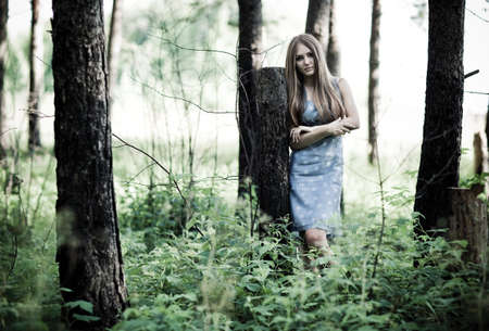 Young woman in a forest. Contrast colors.の写真素材