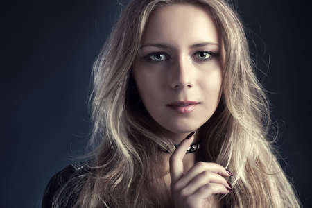 Young woman fashion portrait. On dark background.の写真素材