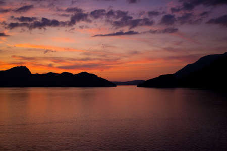 Sunset over the lake in Alps. Dark soft colors.の写真素材