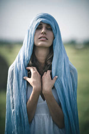 Young woman with long kerchief portrait.の写真素材