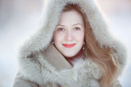 Young woman winter portrait. Bright white colors.の写真素材