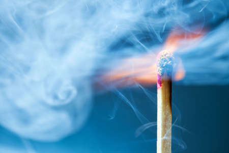 Burning match macro. On blue background.