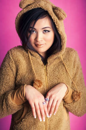 Young japan woman in bear suit. Sweet portrait.の写真素材