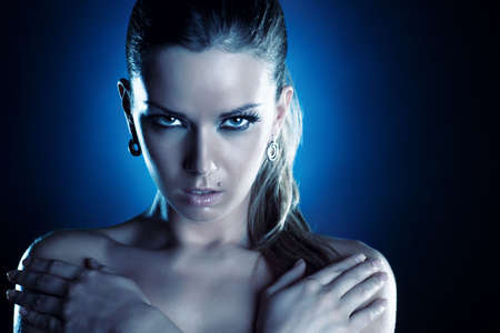 Young woman serious portrait. Cold blue tint.の写真素材
