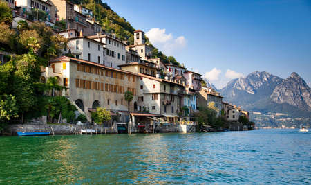 Lugano lake in Switzerland. View on shore with buildings.の写真素材