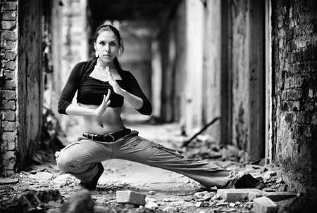 Young woman in a ruined building. Black and white contrast colors.の写真素材