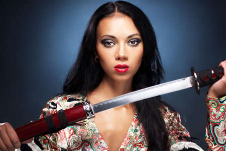 Young woman with samurai sword fashion.の写真素材