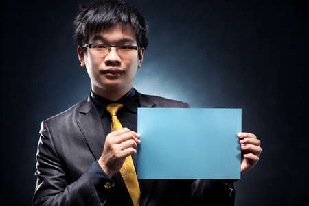 Young japan businessman with blank page. Contrast colors.の写真素材