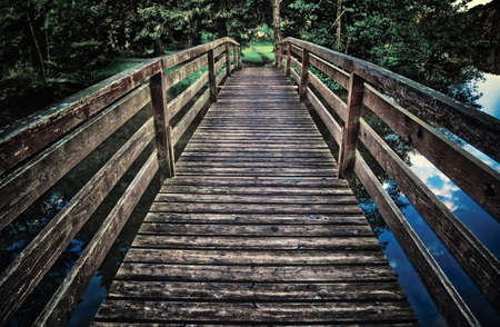 Wooden bridge. Dark contrast colors.