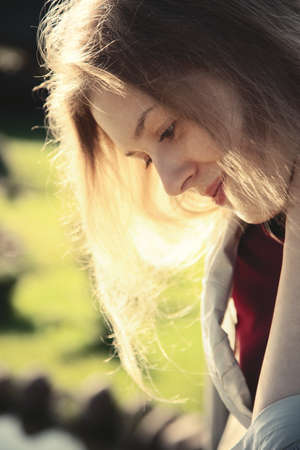 Young pensive woman outdoors portrait.の写真素材