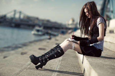 Young schoolgirl sitting on stairs.の写真素材