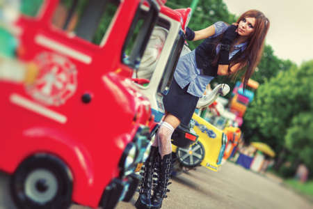 Young schoolgirl in amusement park. Film style colors.の写真素材