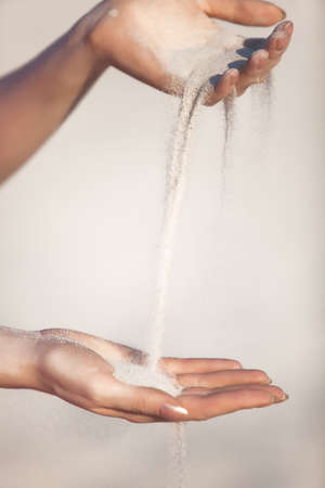 Young woman with sand in hands.の写真素材