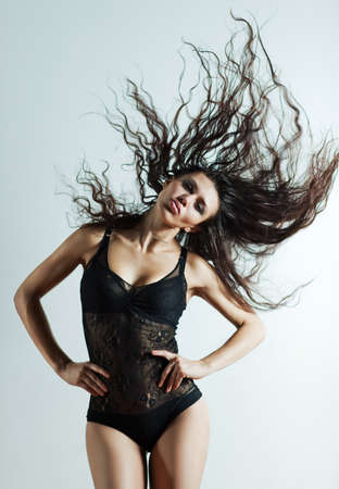 Young sexy woman with fluttering hair.の写真素材