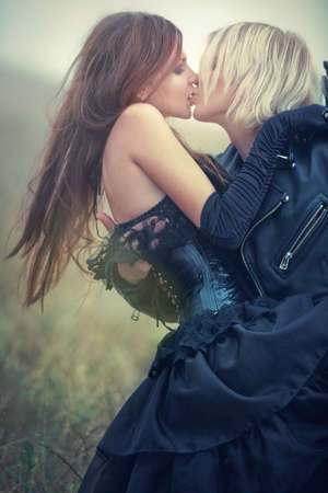 Young goth couple kissing outdoors. Soft colors.の写真素材