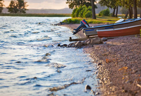 Lake bank with boats. Finland landscape.の写真素材