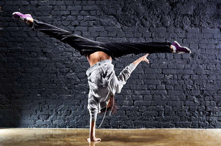 Young woman dancer on wall background. Contrast colors.