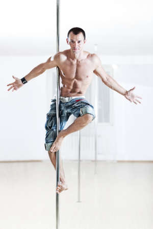 Young strong pole dance man.の写真素材