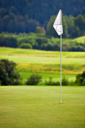 Golf field. Focus on flag.の写真素材